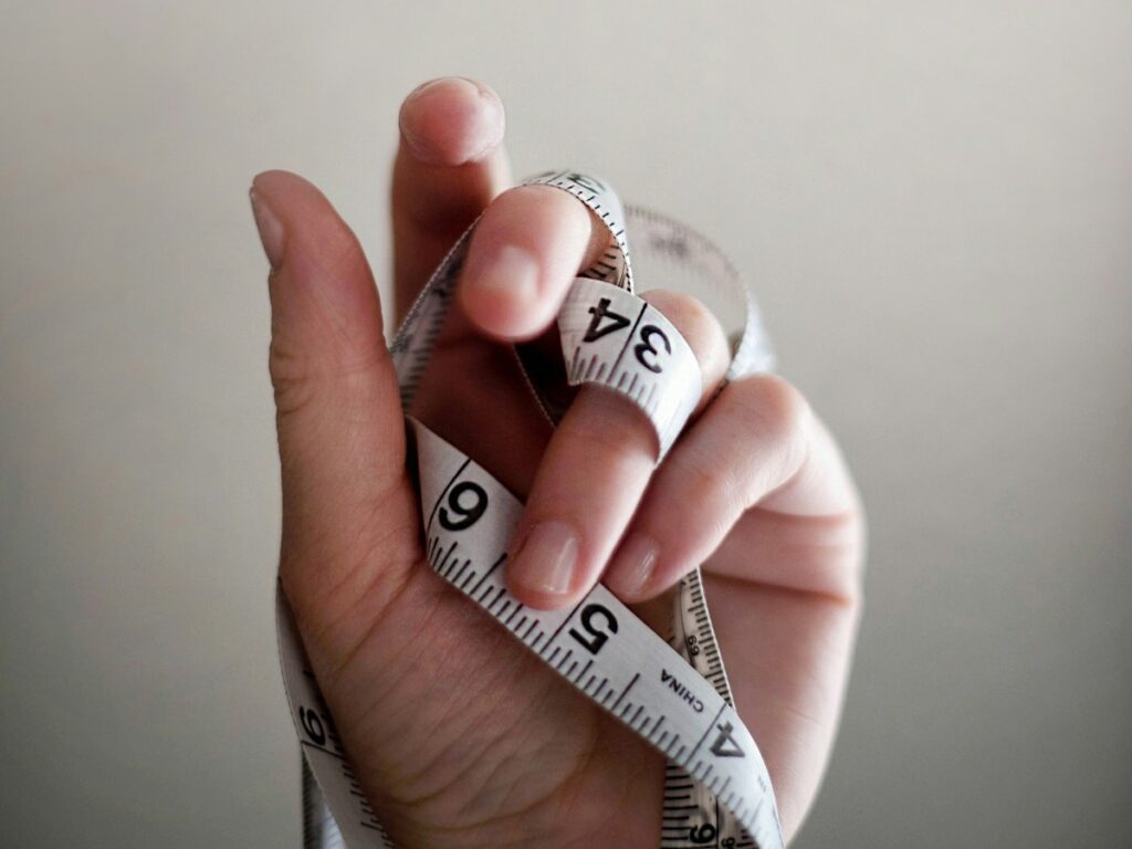 measure tape wrapped around hand